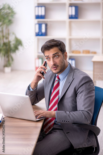 Young male employee working in the office