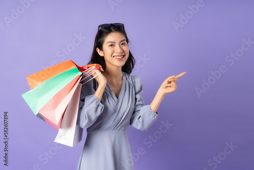 Asian girl in blue dress on purple background