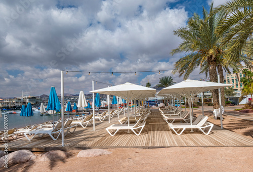 Morning on sandy beach of the Red Sea in Eilat - famous tourist resort and re...