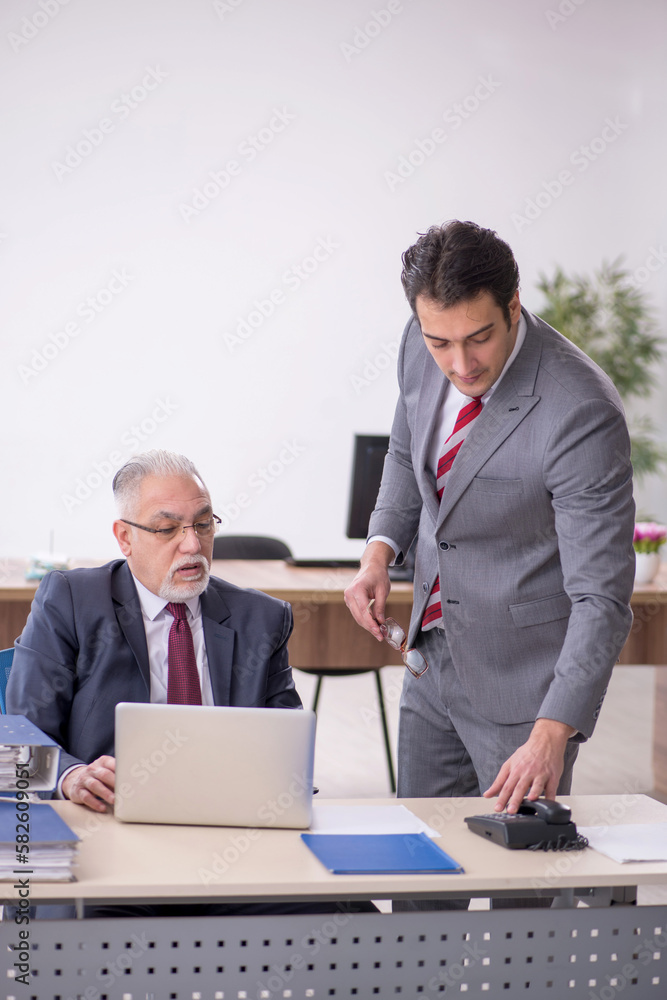 Two male colleagues working in the office Two male colleagues working in the office