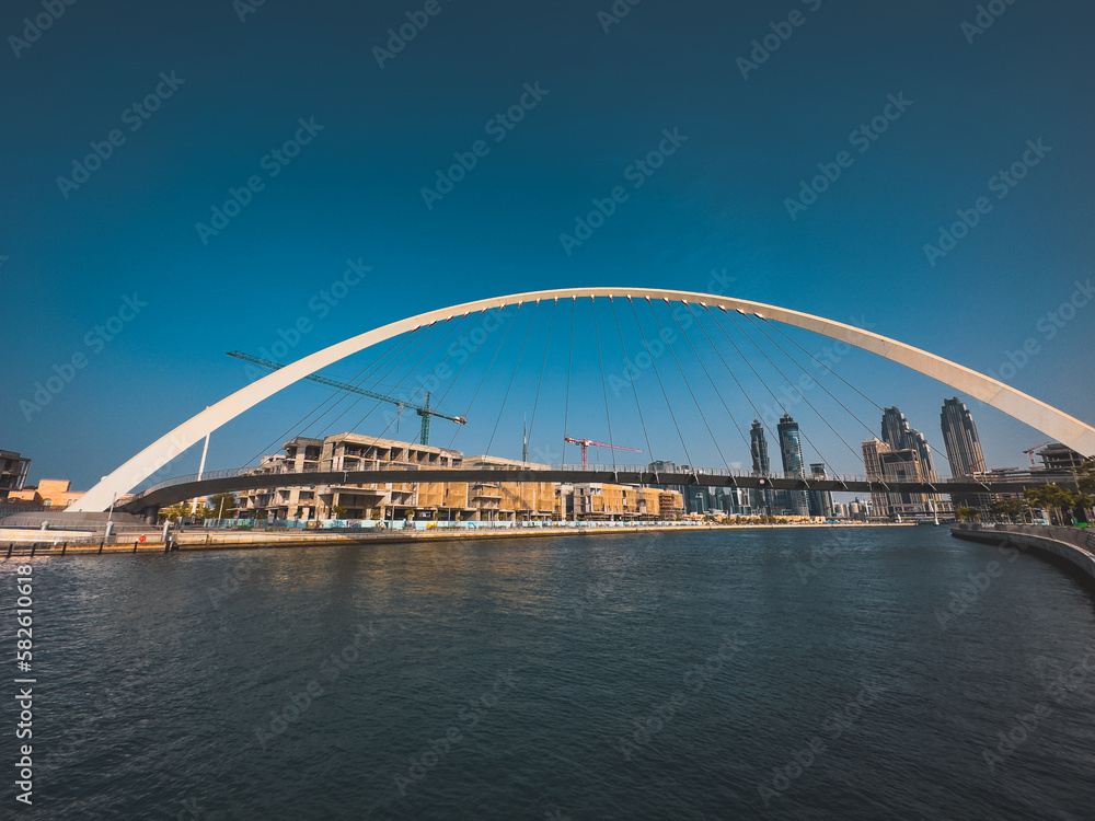 Dubai Water Canal Tolerance Bridge, pedestrian bridge with water taxi, in Dubai, UAE Dubai Water Canal Tolerance Bridge, pedestrian bridge with water taxi, in Dubai, UAE