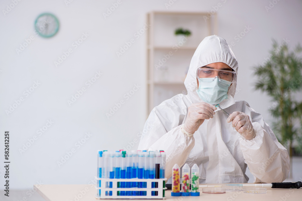 Young male chemist in drugs synthesis concept Young male chemist in drugs synthesis concept