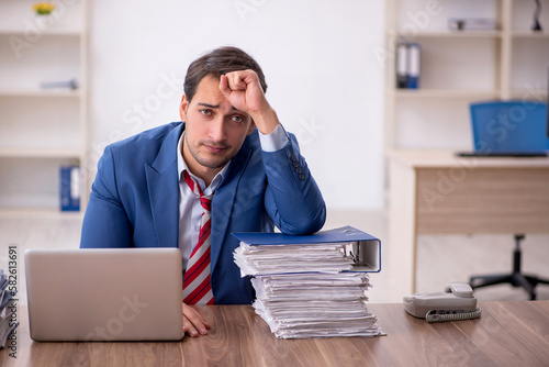 Young male employee working in the office