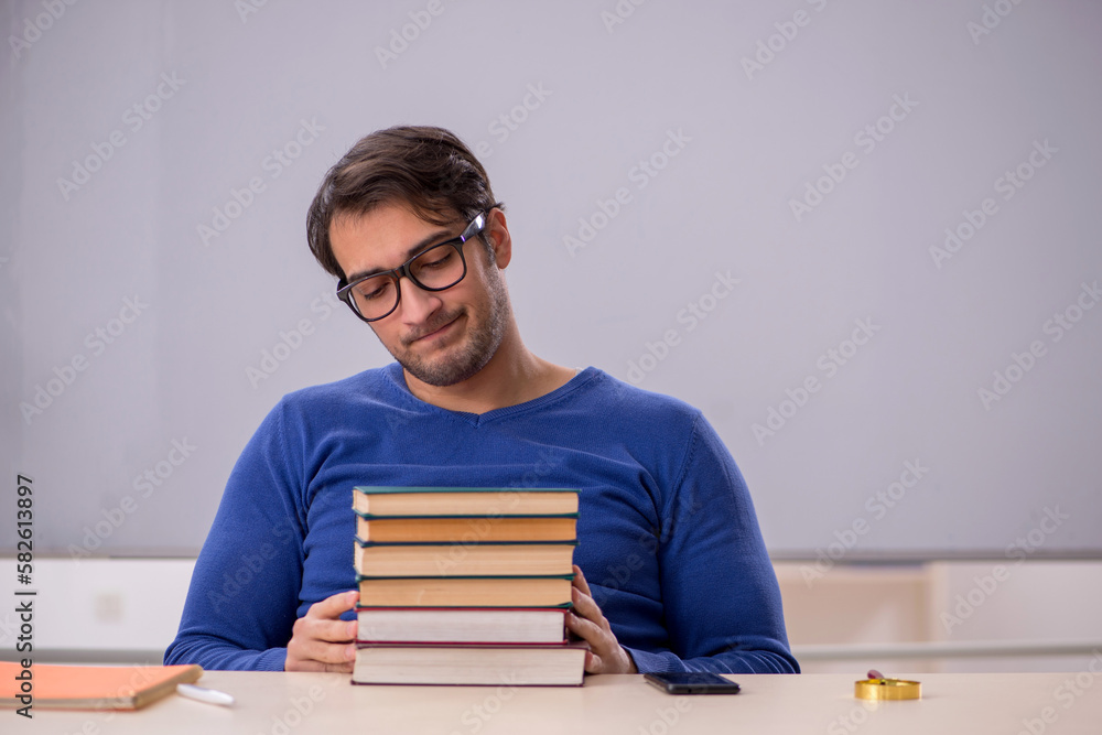 Young male student preparing for exams in the classroom Young male student preparing for exams in the classroom