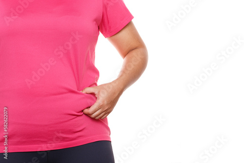 Woman touching his fat belly on white background. Woman hand holding excessive belly fat