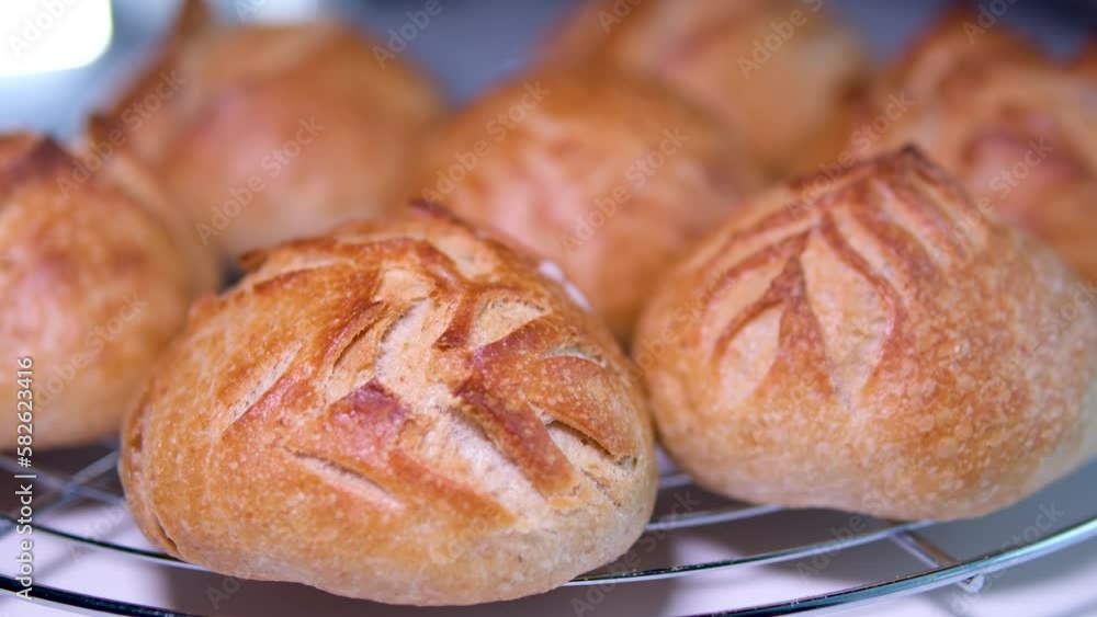 seven buns stand on stand just out of the oven light flashes slowly showing an outline beautiful pattern on each of them bakery products fresh pastries yeast-free dough restaurant serving vitamin B seven buns stand on stand just out of the oven light flashes slowly showing an outline beautiful pattern on each of them bakery products fresh pastries yeast-free dough restaurant serving vitamin B
