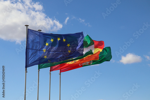 Flags of the European Union, Granada City, Spain, and Andalusia Waving with Blue Clear Sky as the Background
