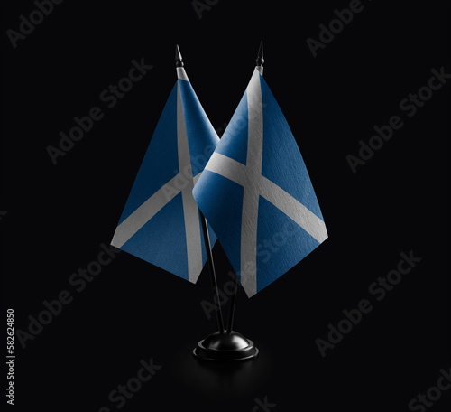 Small national flags of the Scotland on a black background