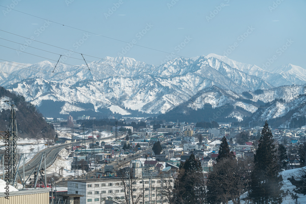 Town surrounded by snowy mountains on Winter season in Yuzawa , Niigata Prefecture, Japan