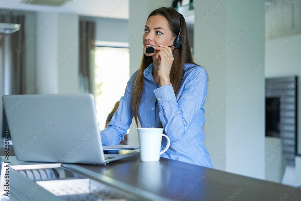 Freelance operator talking with headsets and consulting clients from home office. Freelance operator talking with headsets and consulting clients from home office.