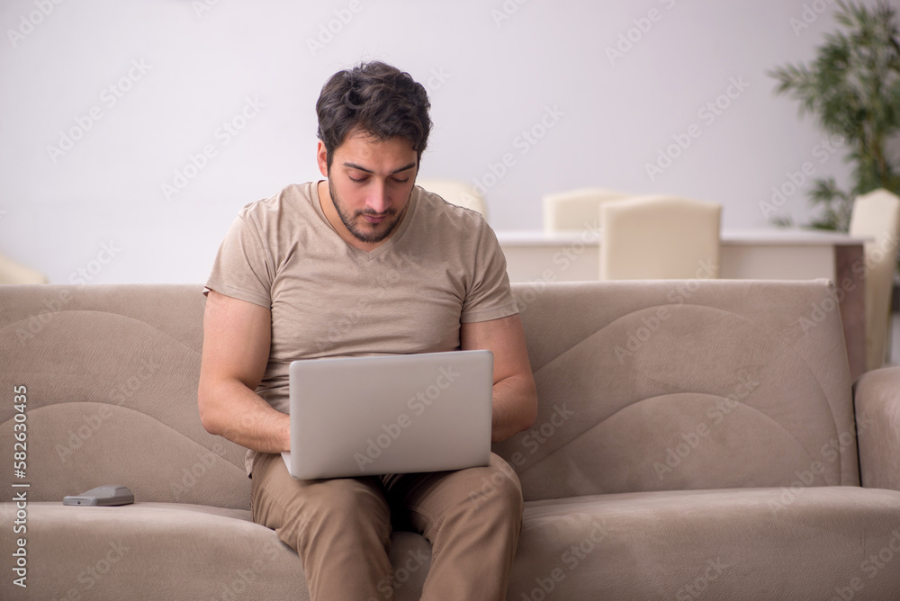 Young male freelancer working from home during pandemic Young male freelancer working from home during pandemic