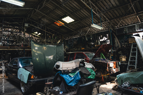 Interior of an old garage full of auto parts and equipment.