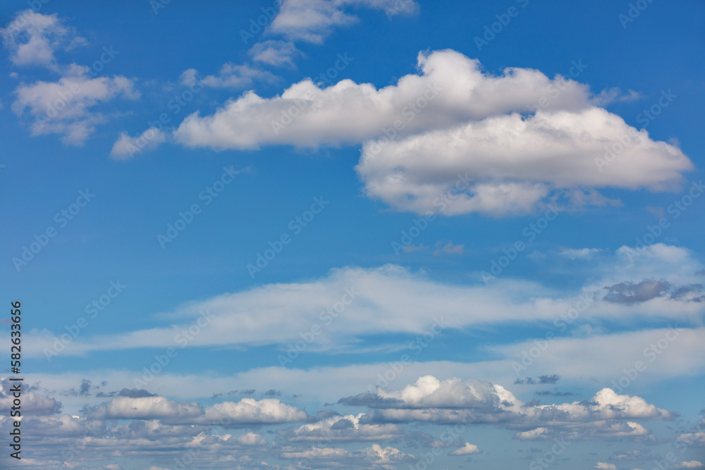 Blue sky background with small white clouds on the horizon. Blue sky background with small white clouds on the horizon.