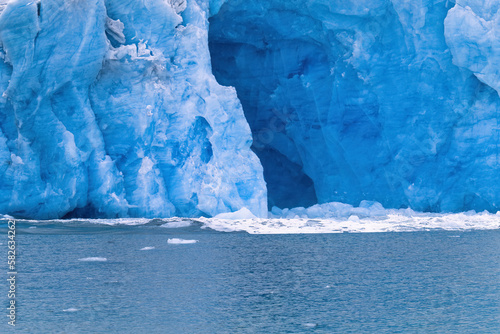 Sea glacier with a cave in the arctic