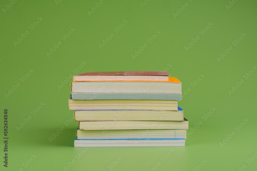 Books. Stack of books stacked on light green background. Reading. Reading concept. and collection of books Books. Stack of books stacked on light green background. Reading. Reading concept. and collection of books