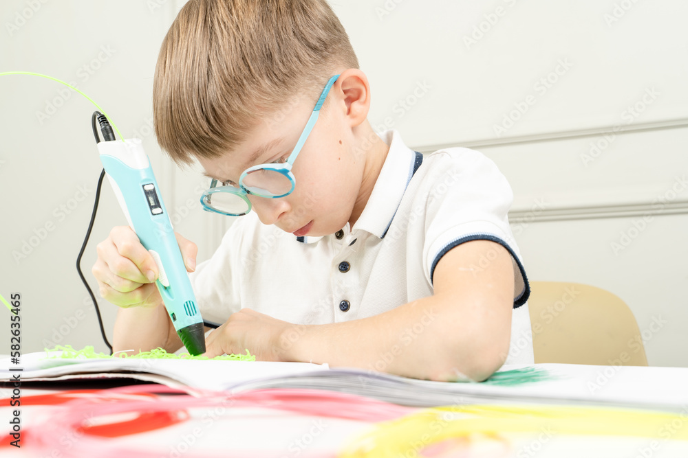 a boy plays with a 3d pen a boy plays with a 3d pen
