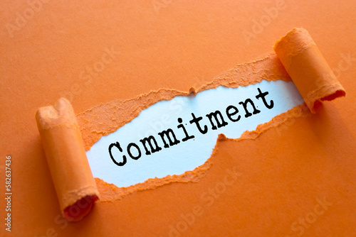 Commitment. Words written under torn paper.