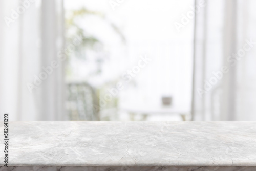 Empty white marble stone table top and blurred living room at home interior with window curtain background. - can used for display or montage your products.