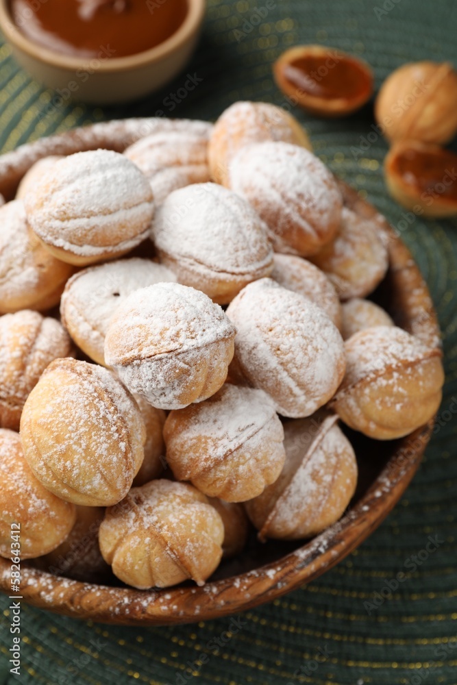 Bowl of delicious nut shaped cookies on table, closeup