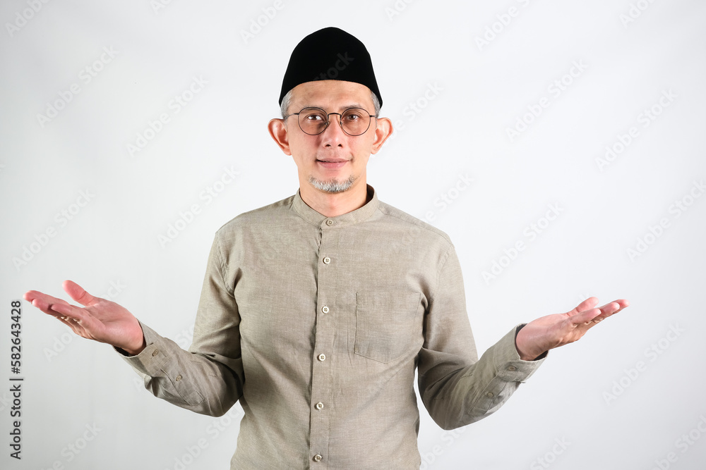Portrait of Moslem Asian Man smiling with arms open when doing greeting pose
Portrait of Moslem Asian Man smiling with arms open when doing greeting pose