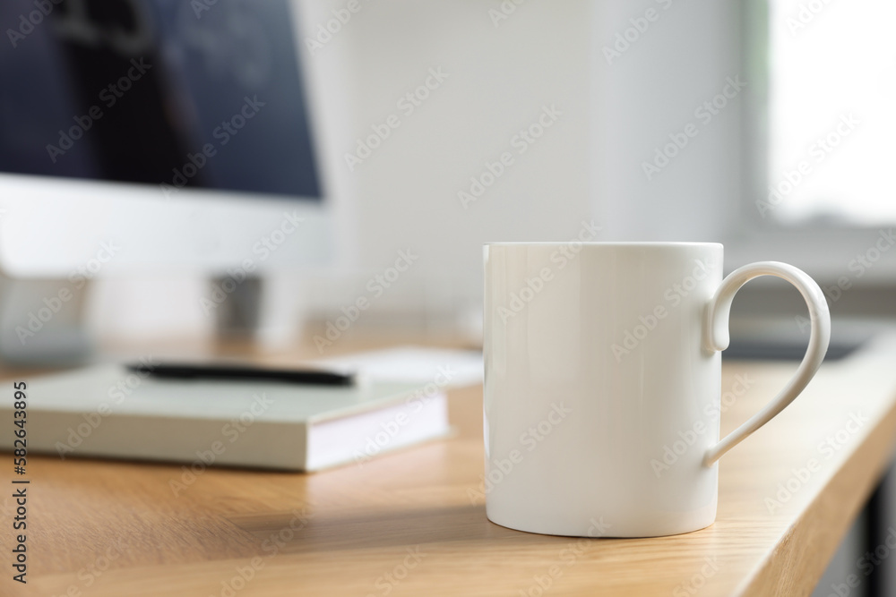 Blank ceramic mug on wooden table. Mockup for design Blank ceramic mug on wooden table. Mockup for design