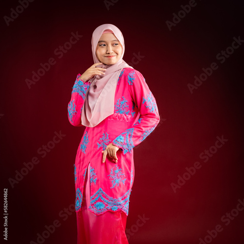 Portrait of a beautiful Asian Muslim female model wearing hijabwear with at a studio photoshoot. Modern hijab fashion and beauty concept