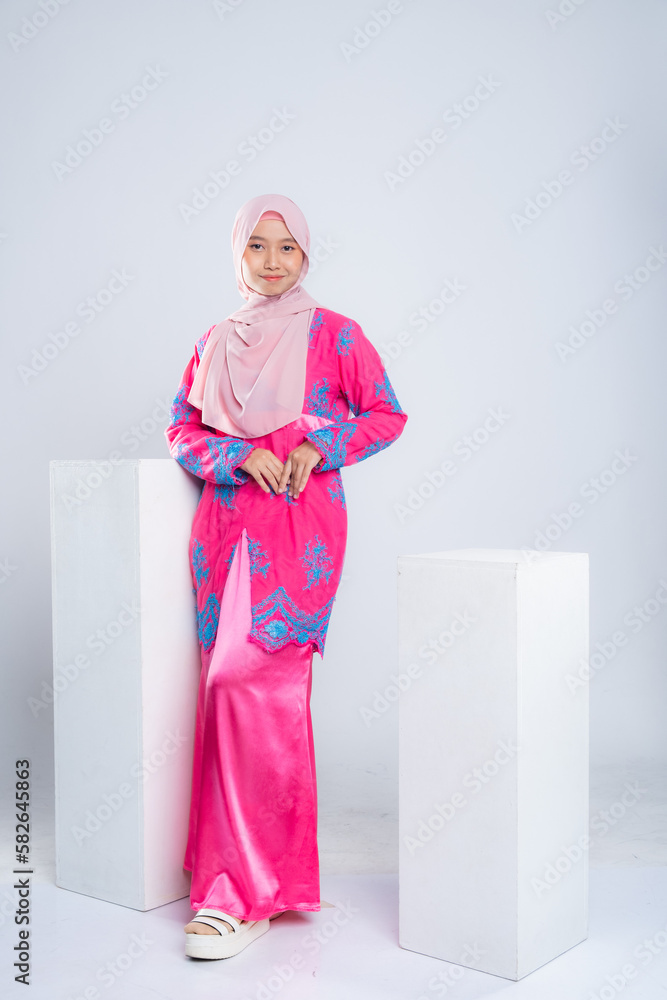 Portrait of a beautiful Asian Muslim female model wearing hijabwear with at a studio photoshoot. Modern hijab fashion and beauty concept Portrait of a beautiful Asian Muslim female model wearing hijabwear with at a studio photoshoot. Modern hijab fashion and beauty concept