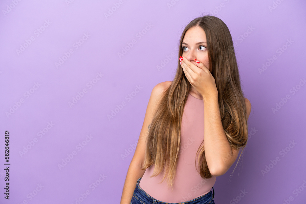 Young Lithuanian woman isolated on purple background doing surprise gesture while looking to the side Young Lithuanian woman isolated on purple background doing surprise gesture while looking to the side