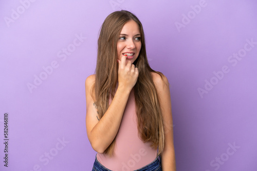 Young Lithuanian woman isolated on purple background nervous and scared