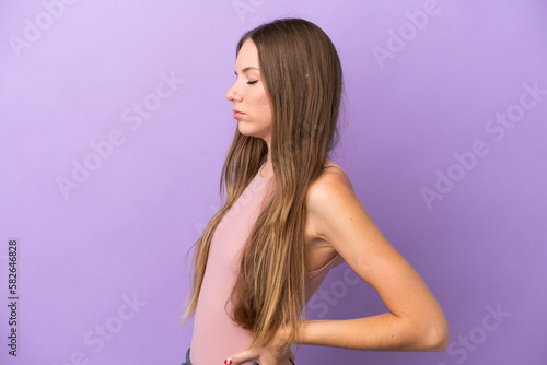 Young Lithuanian woman isolated on purple background suffering from backache for having made an effort
