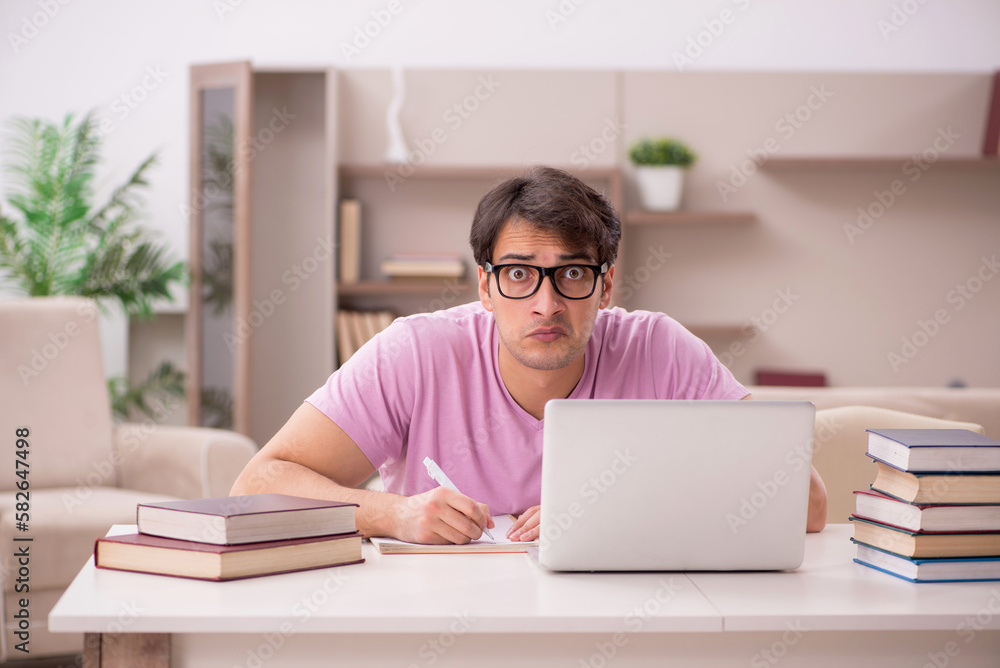 Young male student preparing for exams at home Young male student preparing for exams at home
