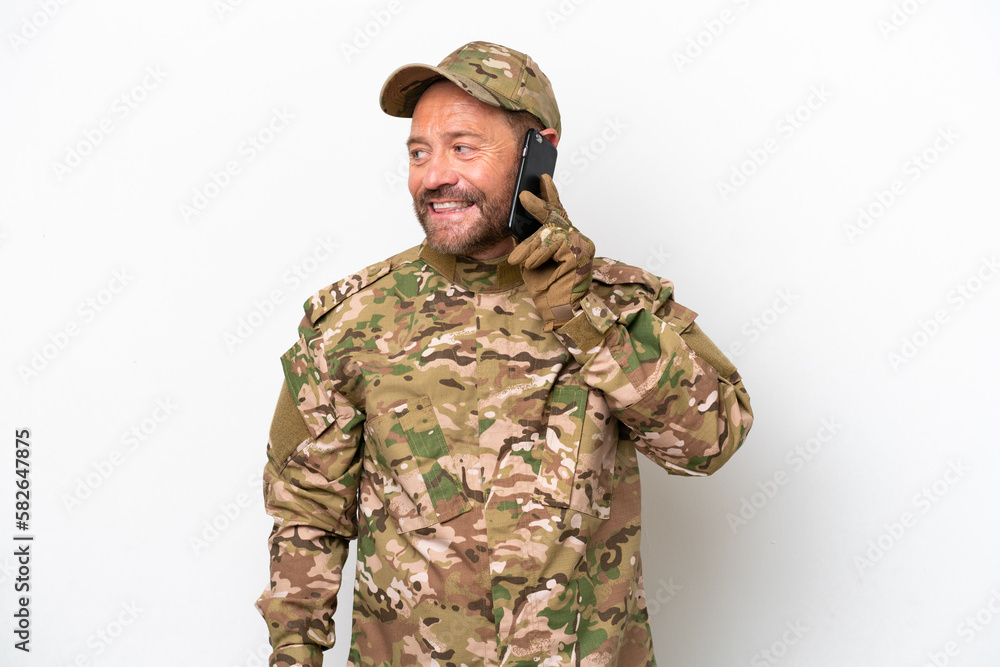 Military man isolated on white background keeping a conversation with the mobile phone with someone Military man isolated on white background keeping a conversation with the mobile phone with someone