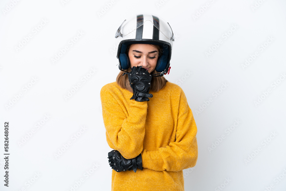 Young caucasian woman with a motorcycle helmet isolated on white background having doubts