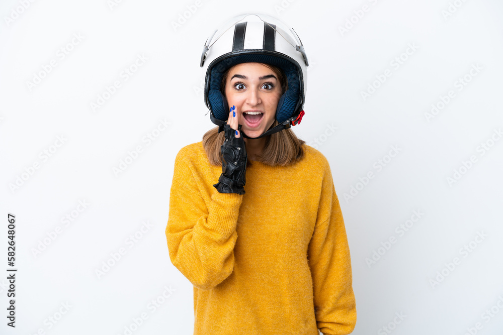 Young caucasian woman with a motorcycle helmet isolated on white background with surprise and shocked facial expression Young caucasian woman with a motorcycle helmet isolated on white background with surprise and shocked facial expression
