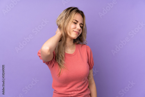 Teenager Russian girl isolated on purple background with neckache
