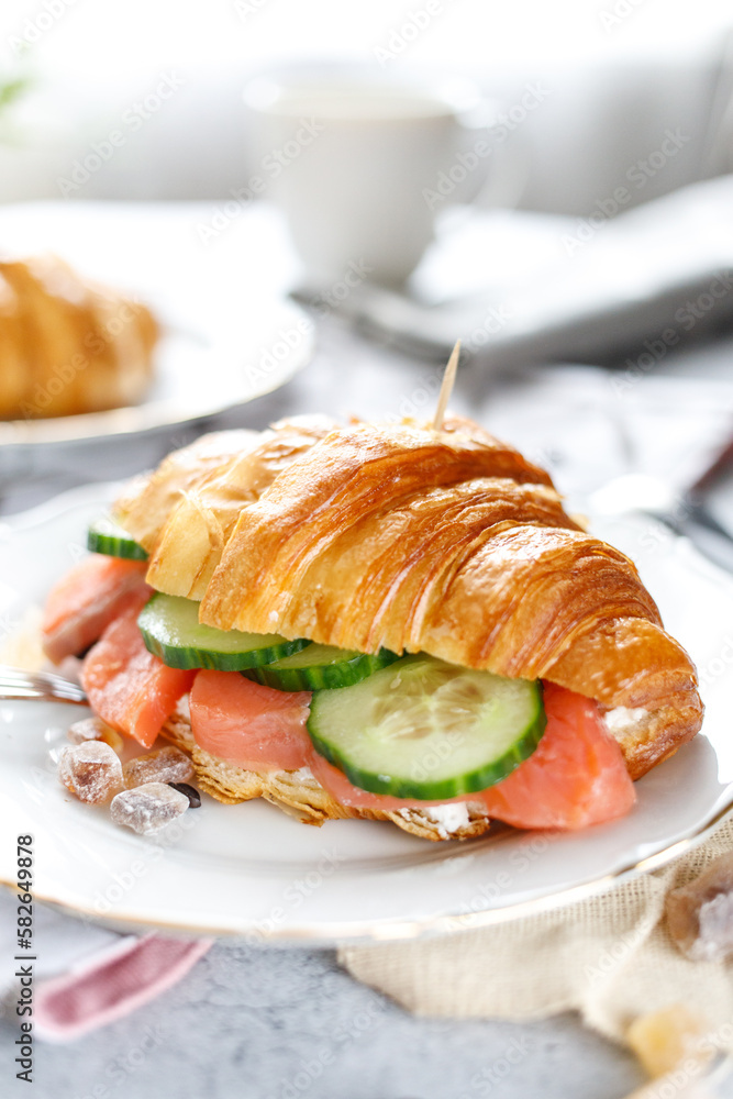 close up croissant with fish on the table in the kitchen light colors close up croissant with fish on the table in the kitchen light colors