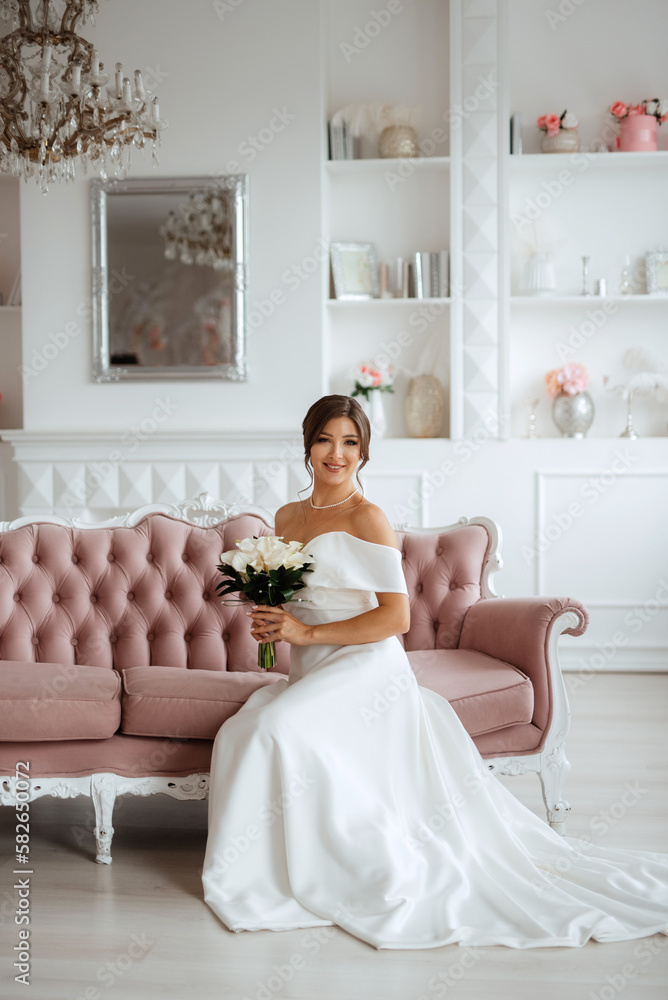 brunette bride in a tight wedding dress in a bright studio brunette bride in a tight wedding dress in a bright studio