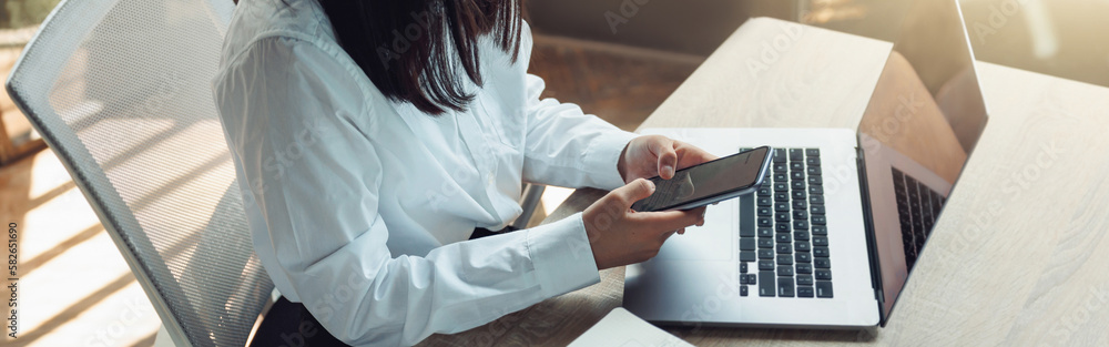 Close up of business woman hands holding phone while sitting in office on his workplace Close up of business woman hands holding phone while sitting in office on his workplace
