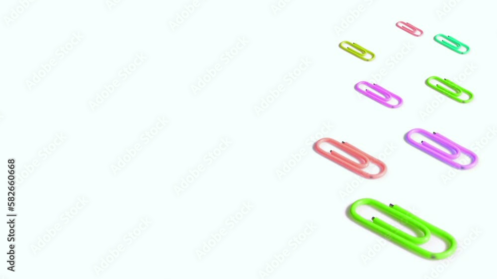 Colorful paper clips spin on white background Colorful paper clips spin on white background