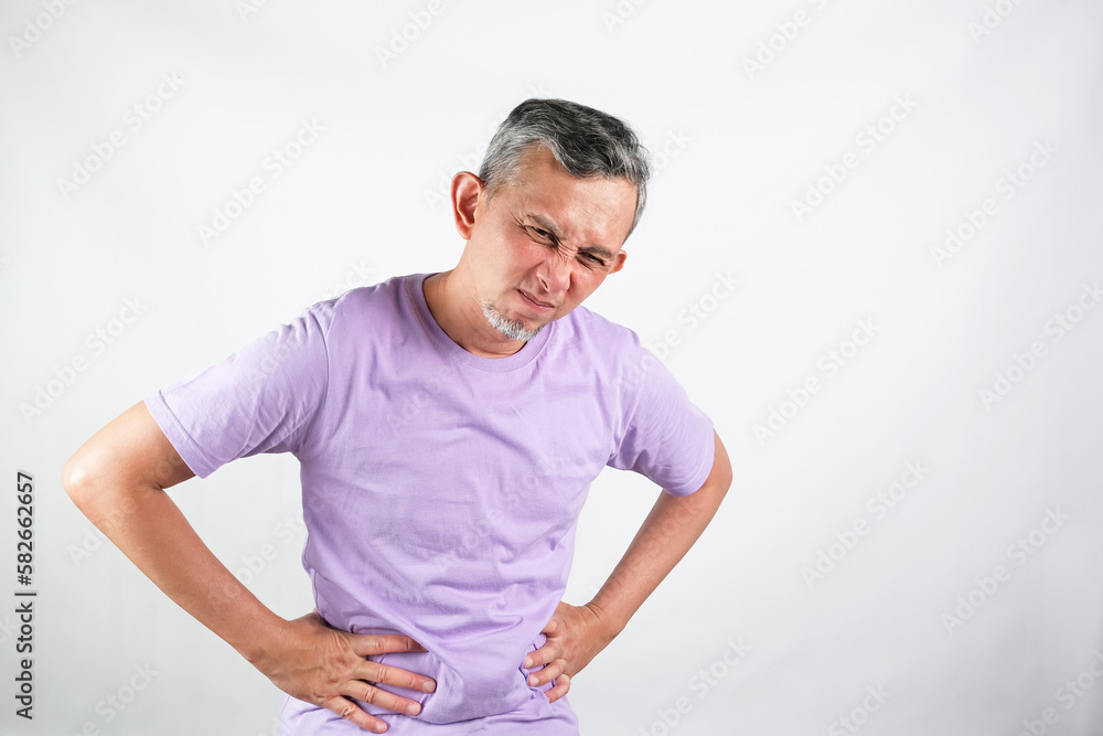 Portrait of Asian Man suffering from painful stomach ache
Portrait of Asian Man suffering from painful stomach ache