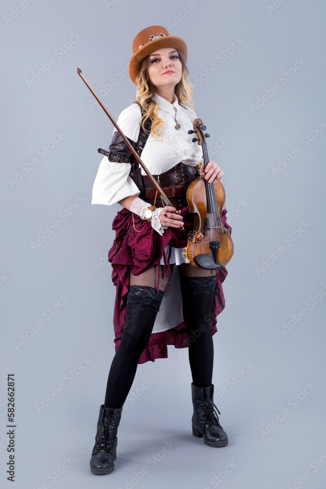 Country girl with violin on the grey background. Country girl with violin on the grey background.