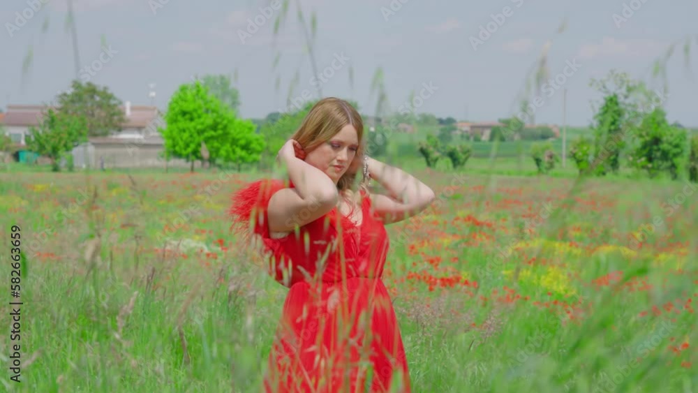Young girl with red dress walks among the nature Young girl with red dress walks among the nature
