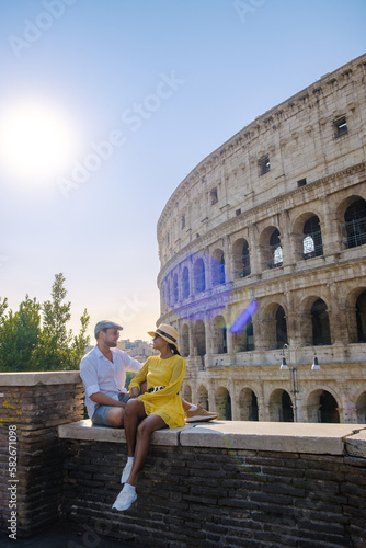 Young couple mid age on a city trip in Rome Italy Europe, Colosseum Coliseum building in Rome, Italy at summer