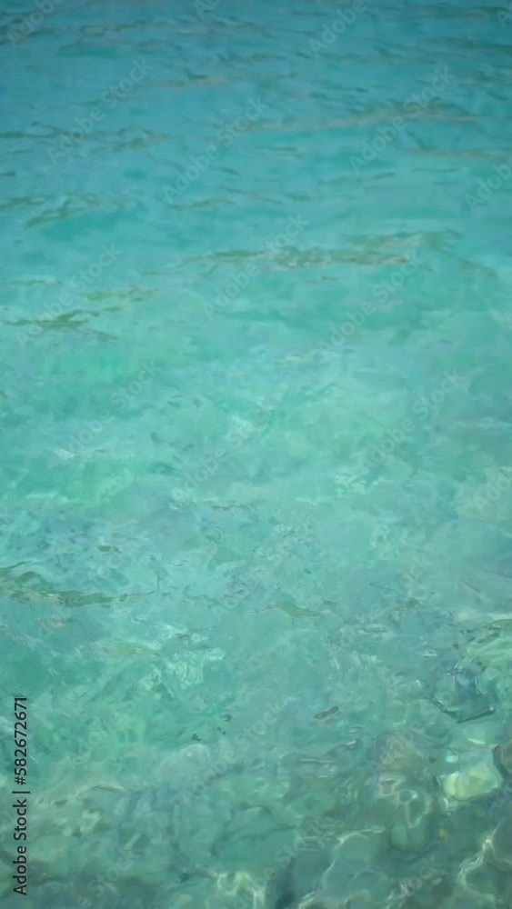 Vertical video of turquoise blue sea and ocean waters on a sunny day in summer Vertical video of turquoise blue sea and ocean waters on a sunny day in summer