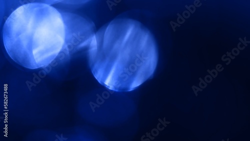 Abstract dark blue natural optical bokeh loop background. Organic defocus overlay 3D illustration on textured lens and cinematic look. Product showcase and copy space template backdrop studio shot
