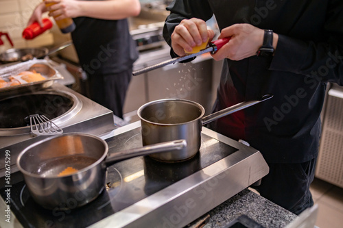 Chef hands cooking sauce in the restaurant kitchen
