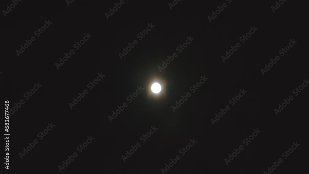 A time-lapse video of a full moon illuminating the cloudy night sky. A time-lapse video of a full moon illuminating the cloudy night sky.
