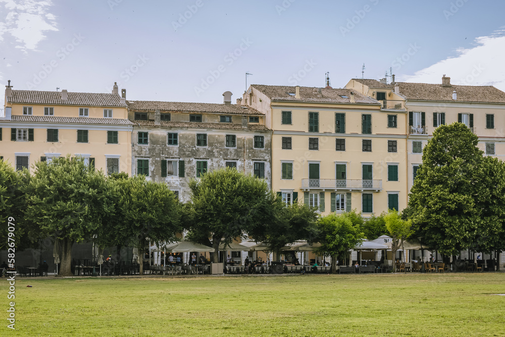 Naklejka premium Buildings around Cricket Pitch on Spianada Square in historic part of Corfu city, Corfu Island, Greece