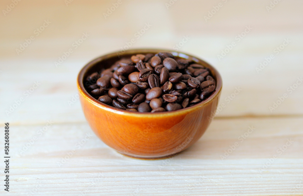 close-up of brown coffee beans in a bowl, coffee beans background, coffee beans in a bowl on wooden table, space for text, roasted coffee beans close-up of brown coffee beans in a bowl, coffee beans background, coffee beans in a bowl on wooden table, space for text, roasted coffee beans