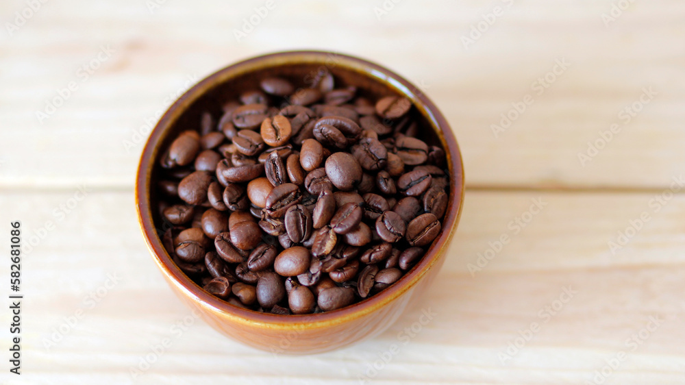 close-up of brown coffee beans in a bowl, coffee beans background, coffee beans in a bowl on wooden table, space for text, roasted coffee beans close-up of brown coffee beans in a bowl, coffee beans background, coffee beans in a bowl on wooden table, space for text, roasted coffee beans
